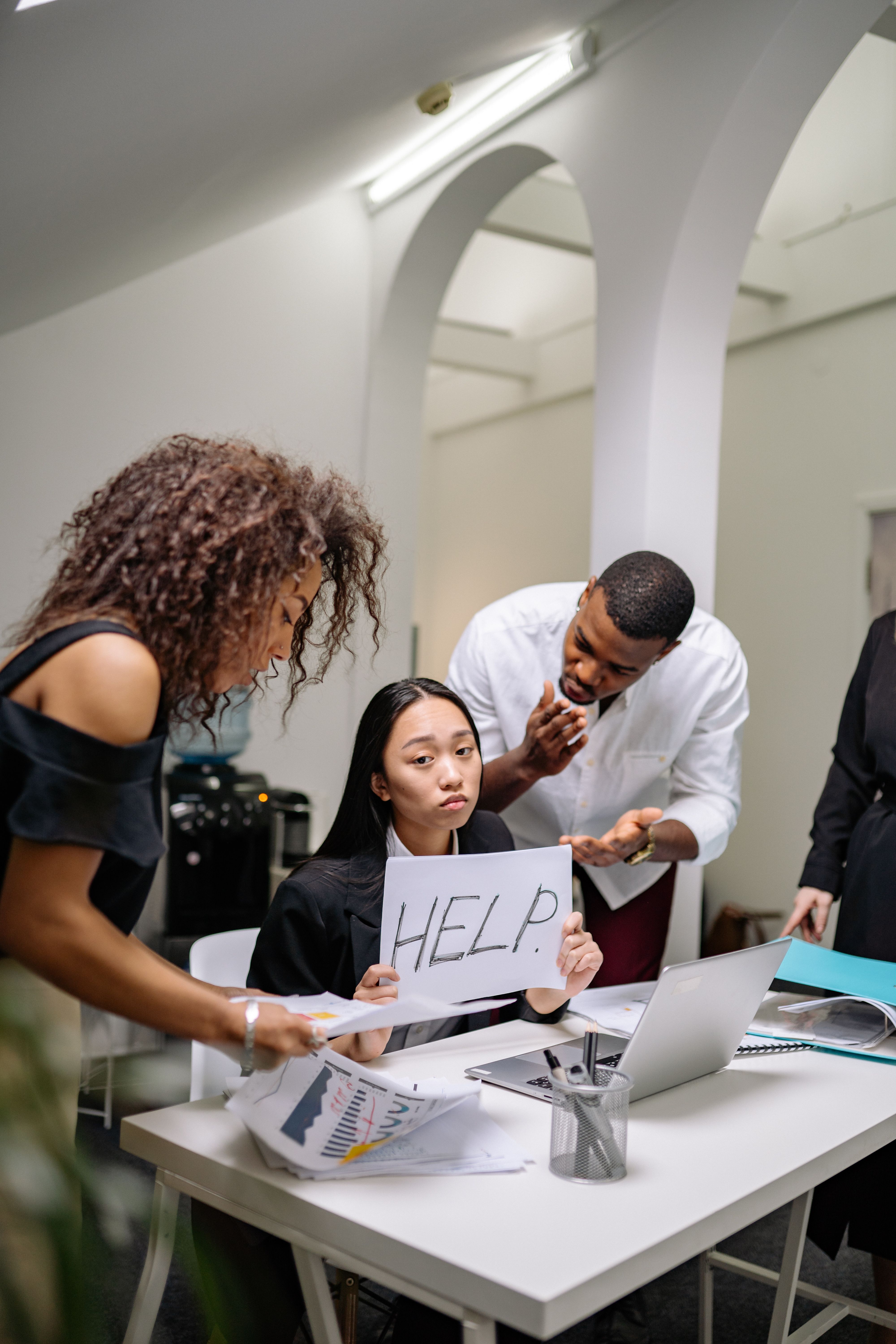 Overwhelmed business owner holding HELP sign — AI By Genius solves that